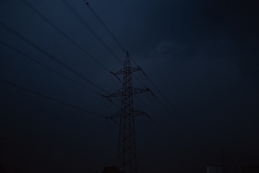 black electric tower under dark sky