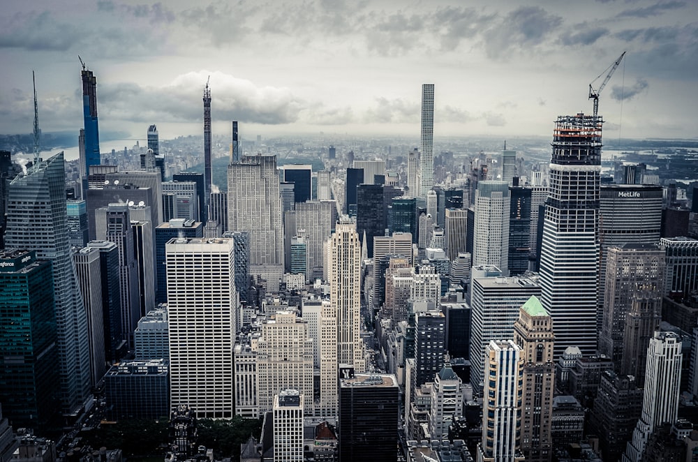 city skyline under white clouds during daytime