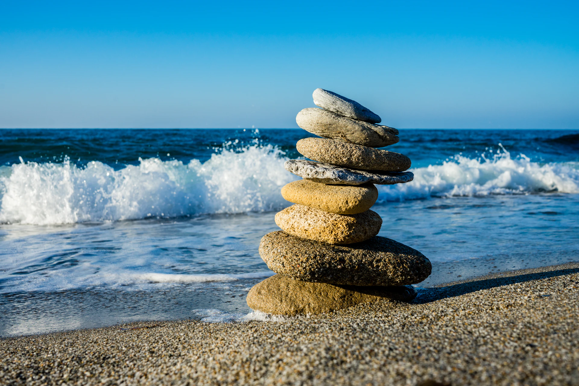 stack of stones on beach during daytime