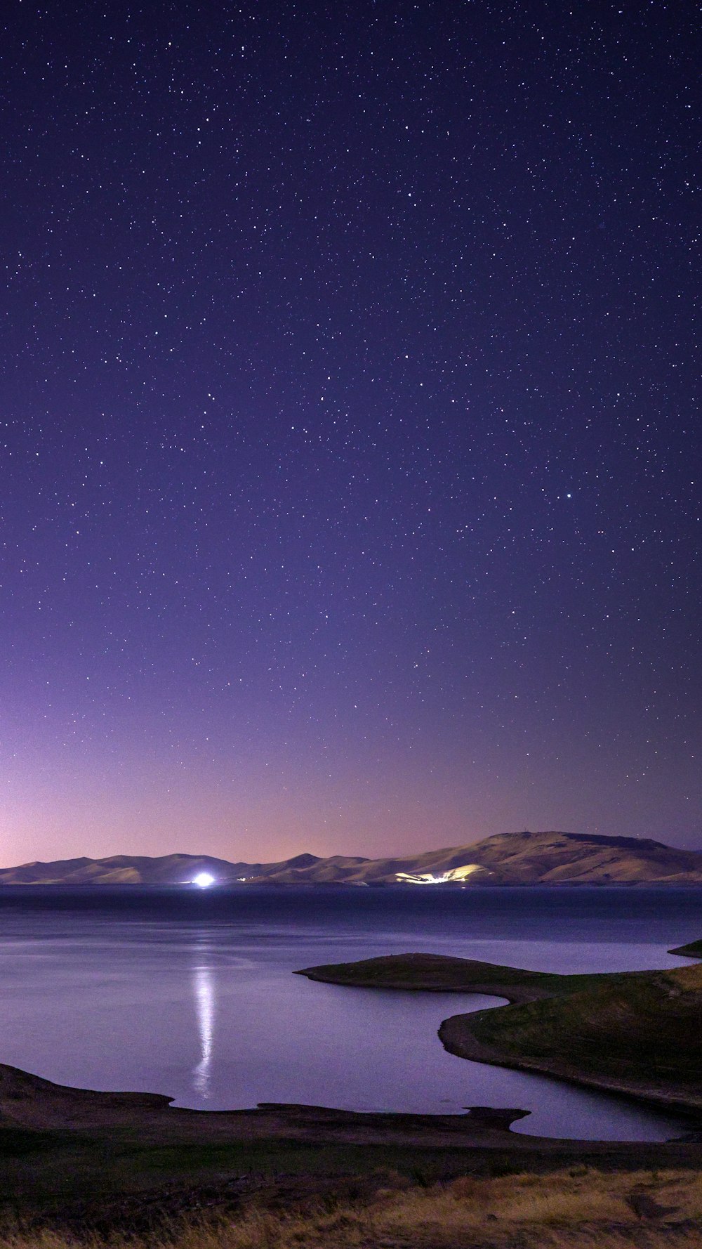 body of water under blue sky during night time