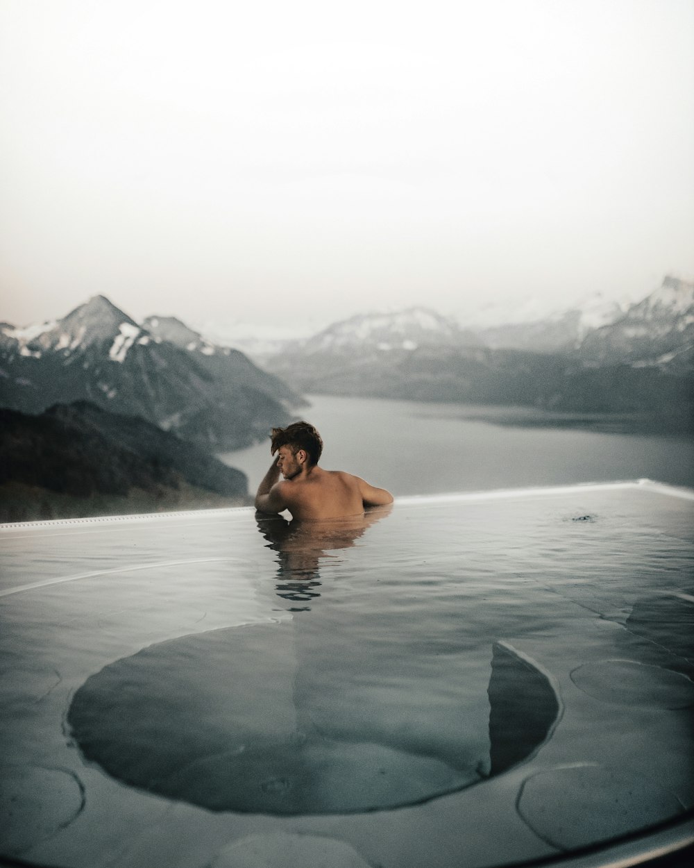 topless man in water during daytime