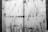 A monochrome image depicts a rough, scratched surface with the words 'YOUR ANGER IS A GIFT' stenciled in bold capital letters. The background appears to be metal with various markings and scratches.