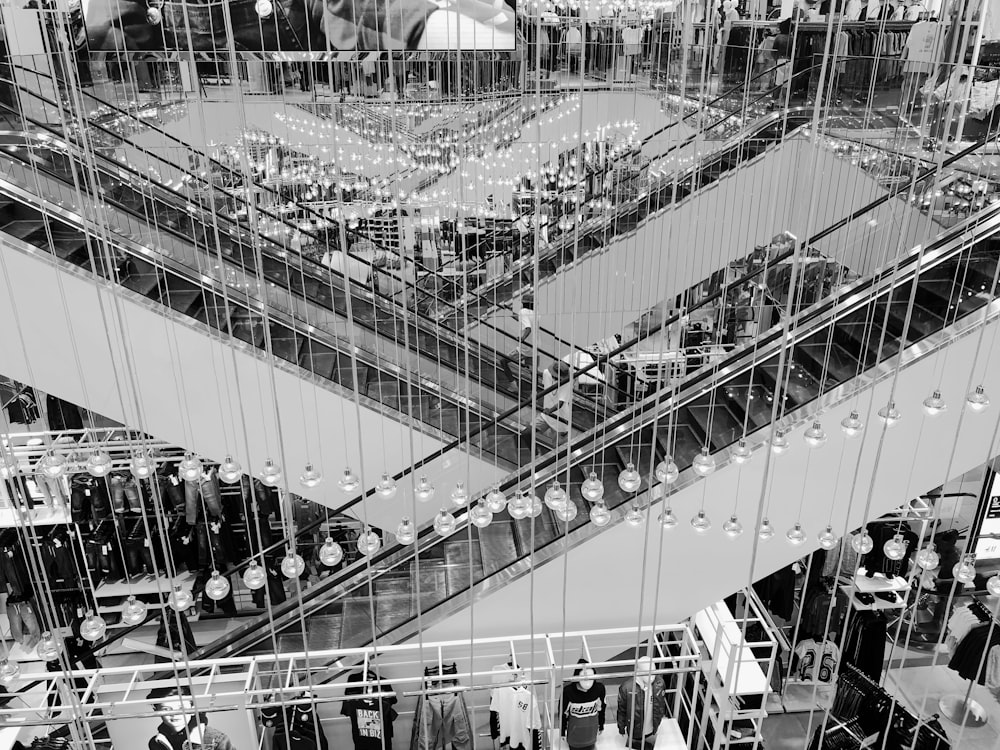 grayscale photo of people walking on the bridge