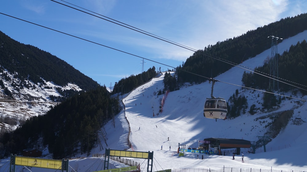 cable cars over snow covered mountain during daytime