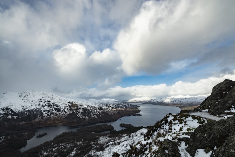 snow covered mountain under cloudy sky during daytime