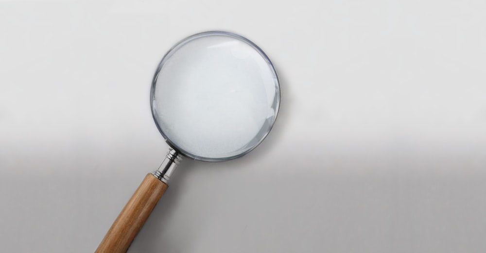 magnifying glass on white table