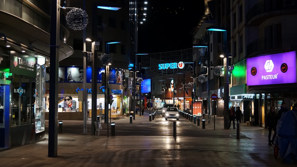 people walking on sidewalk during night time