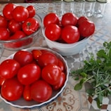 A cozy kitchen counter with fresh vegetables and canning jars ready for preserving.