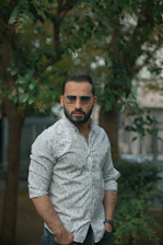 man in gray button up shirt wearing black sunglasses