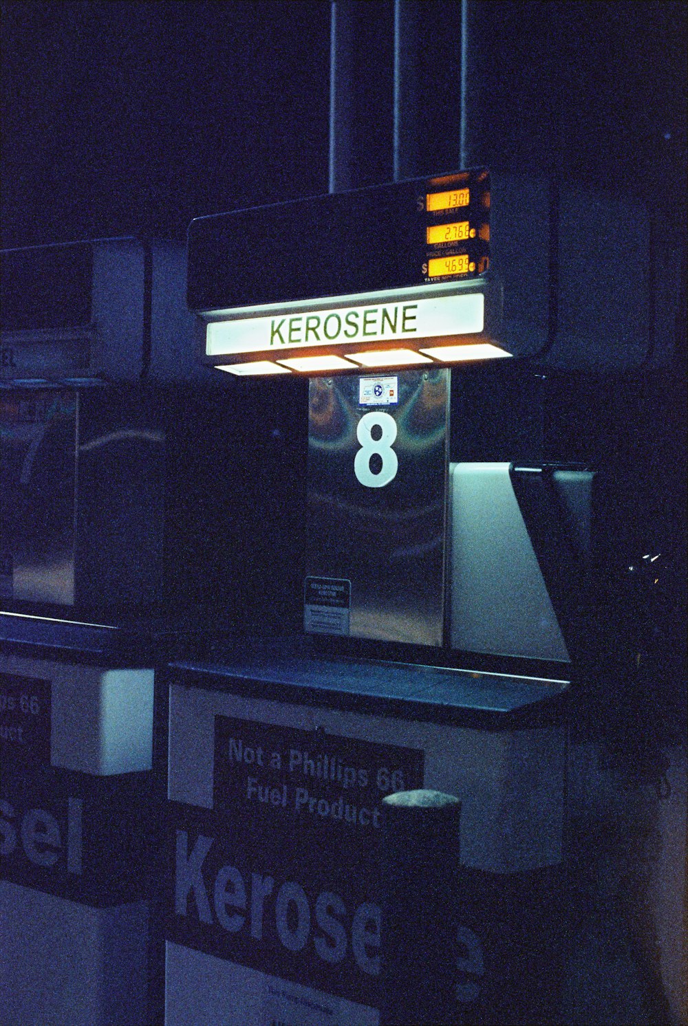 a gas station sign lit up at night
