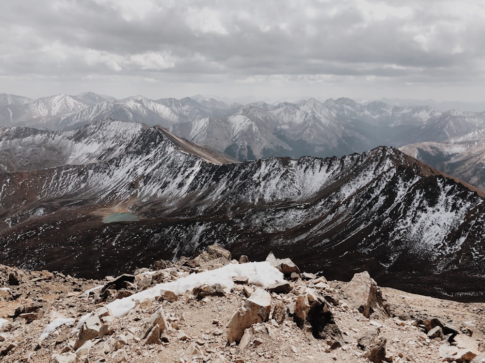 rocky mountain under white clouds during daytime