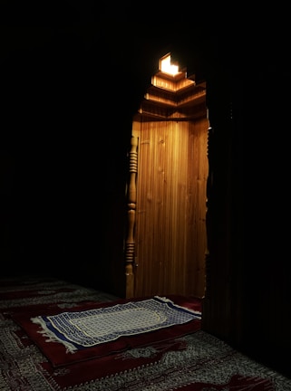 Interior shot showing rows of prayer rugs bathed in soft morning light.