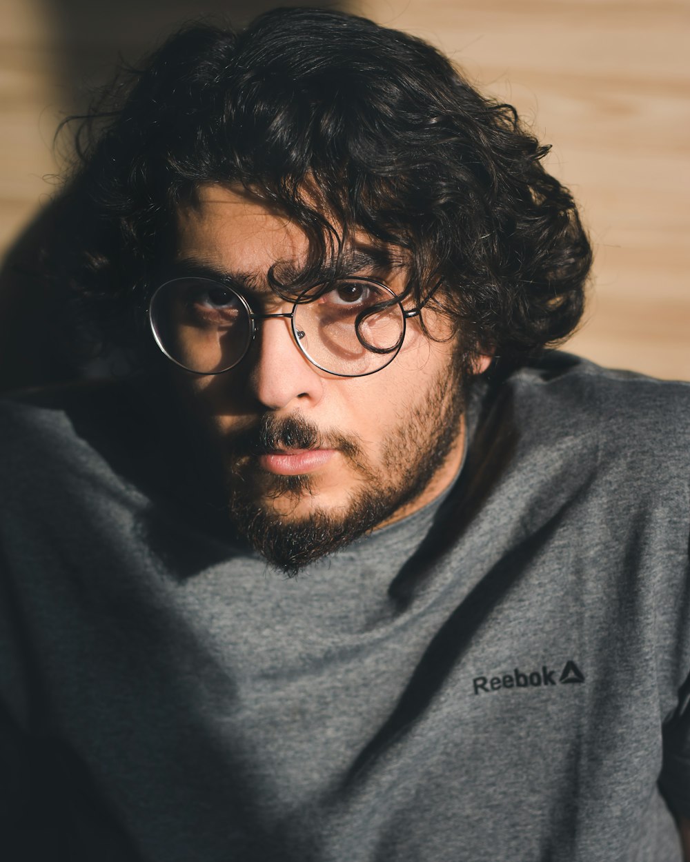 man in black crew neck shirt wearing black framed eyeglasses