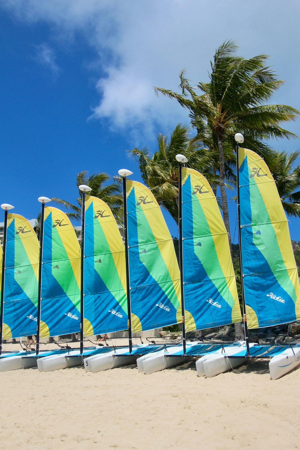 green and yellow flags on white boat during daytime