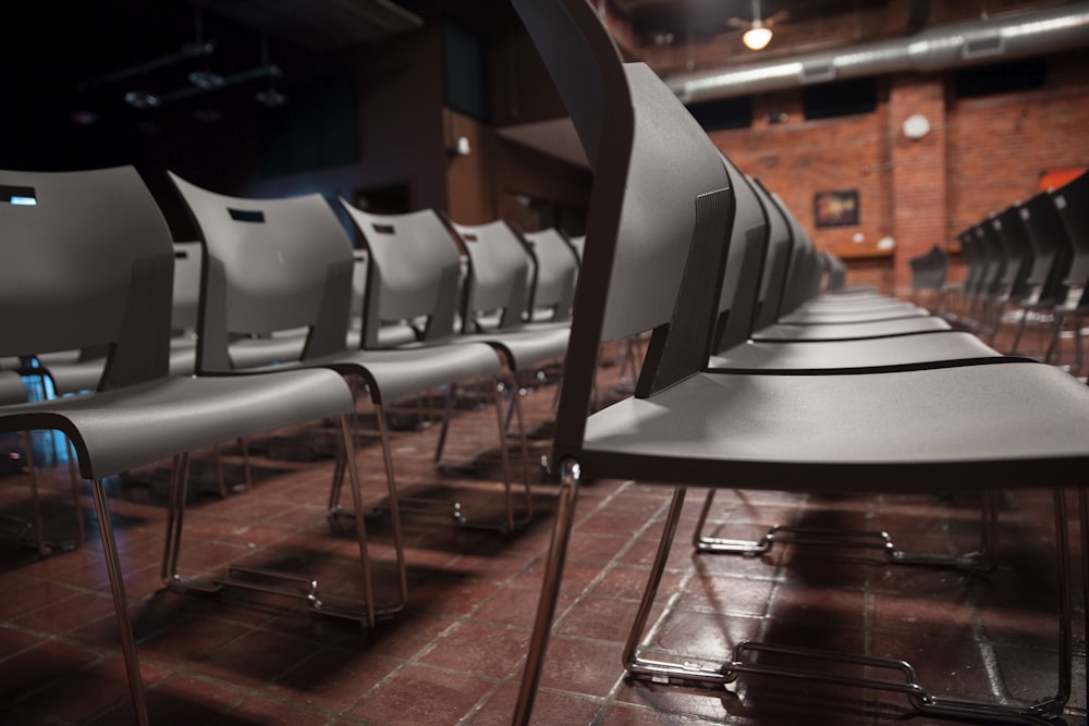 white and gray chairs on brown wooden floor