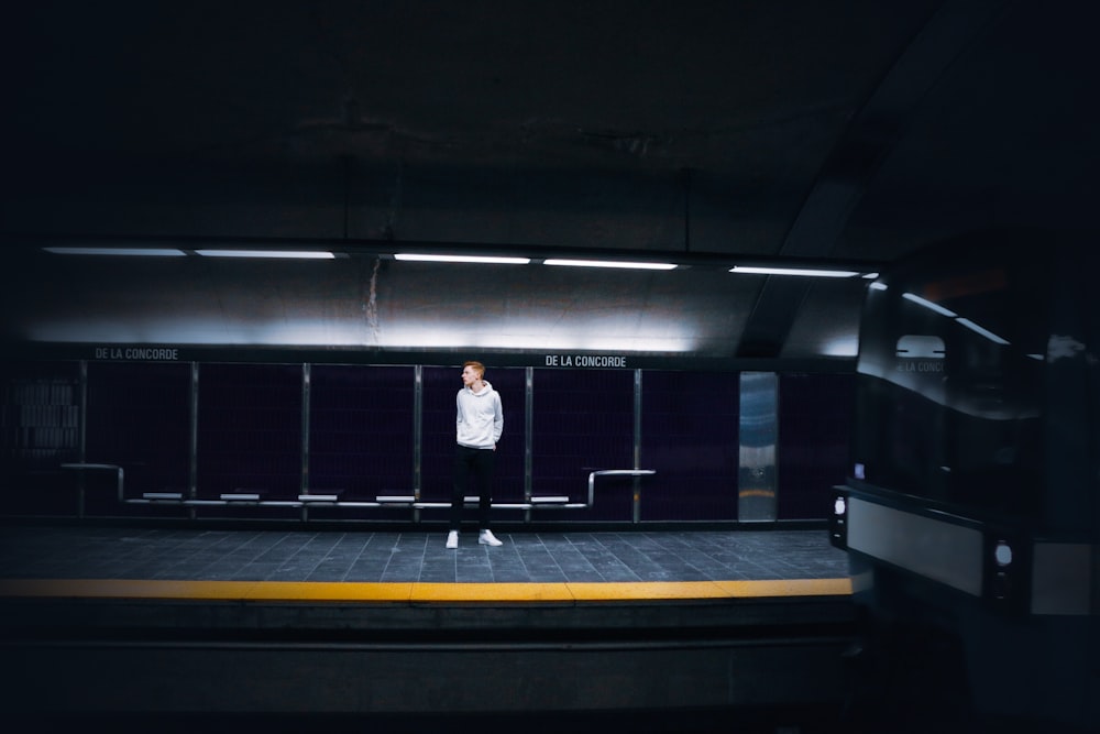a man standing on a platform in a dark room