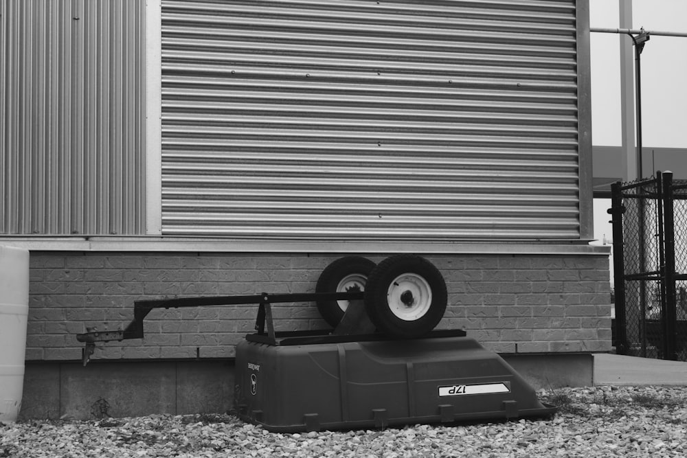 black plastic trash bin beside roll up door