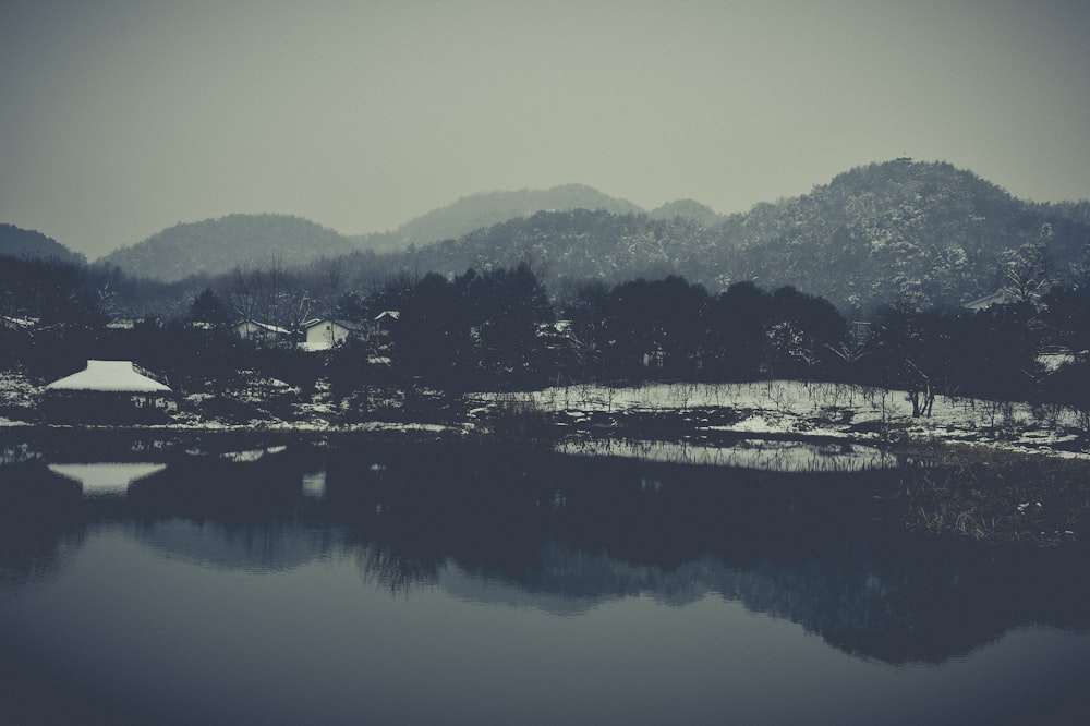 body of water near mountain during daytime