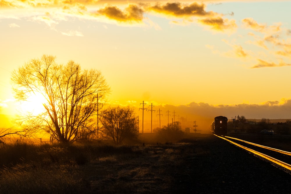 black car on road during sunset