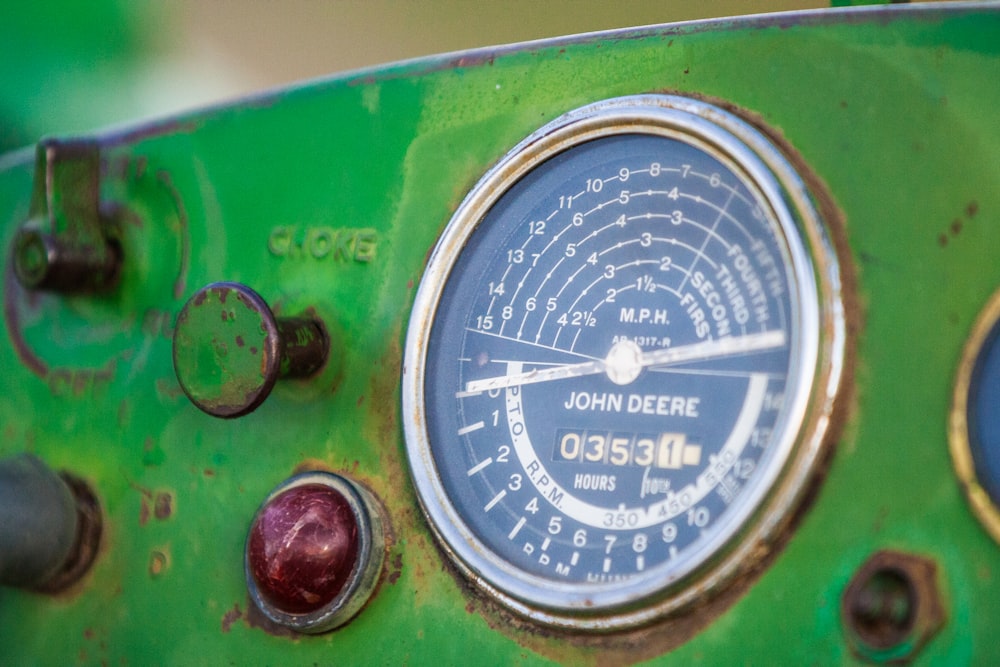 green and silver analog gauge