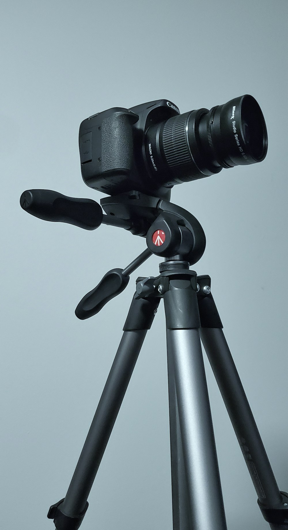 black dslr camera on tripod