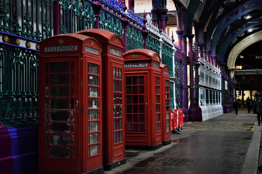 red telephone booth in the middle of the street