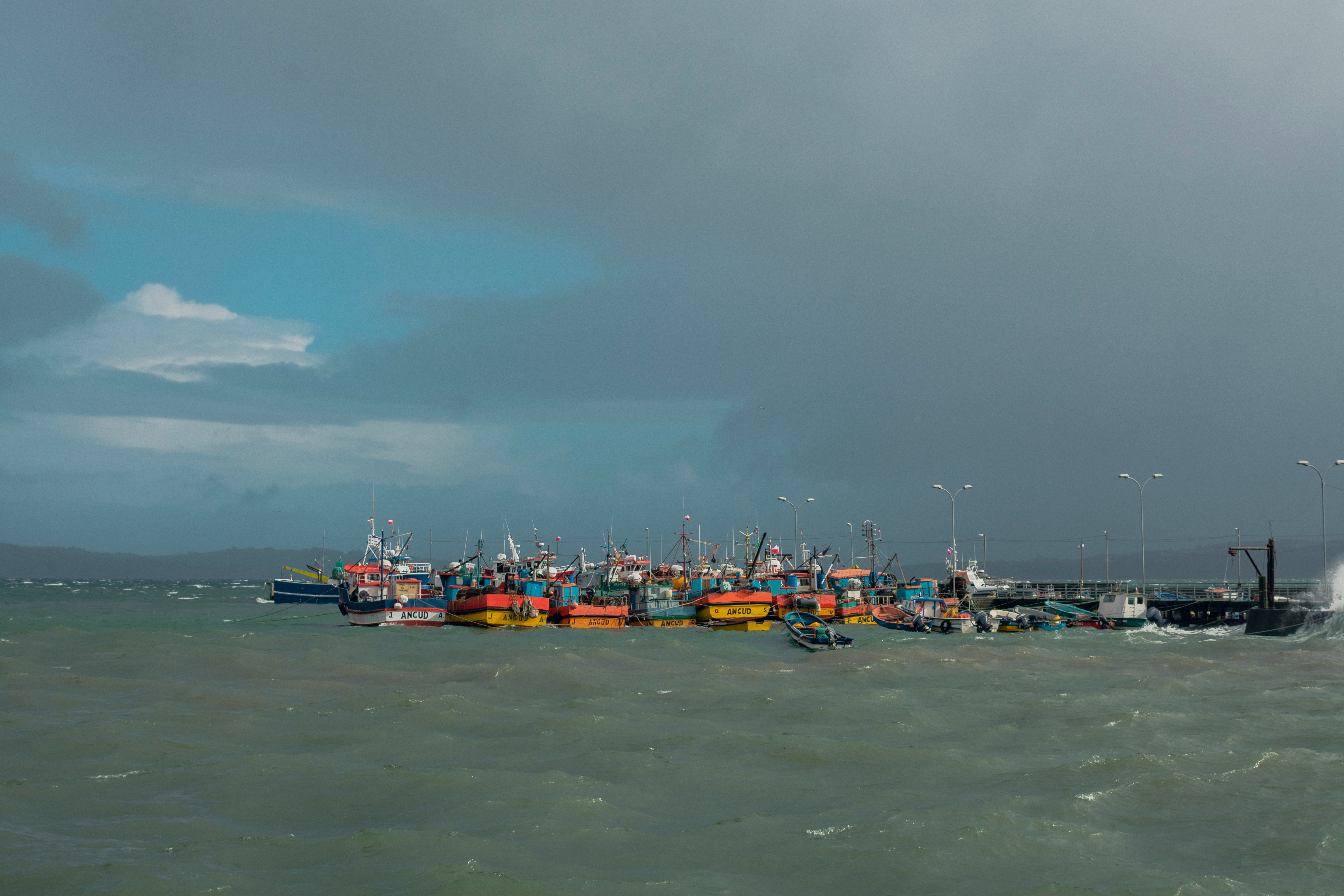 boat on sea under gray sky