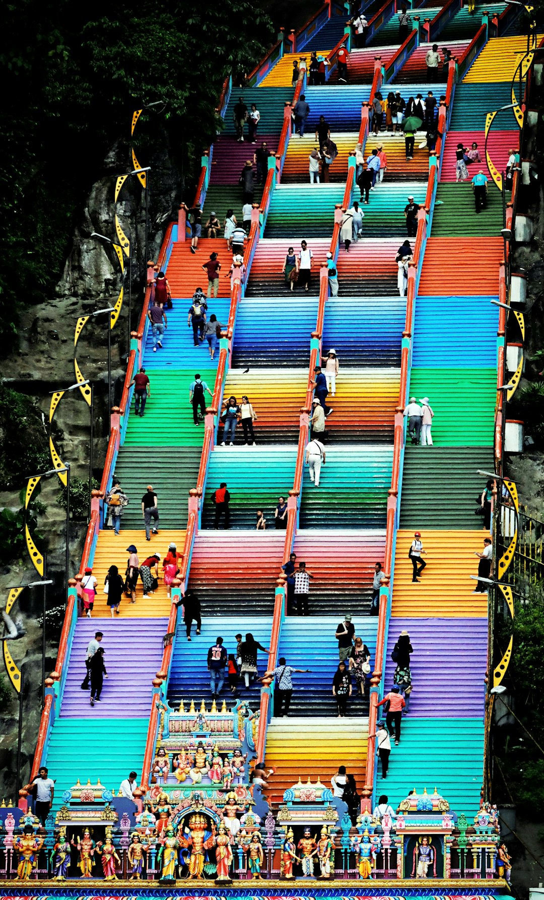 people sitting on green and orange wooden stairs during daytime