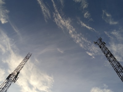 Wireless communication towers with clear blue sky in the background symbolizing connectivity.