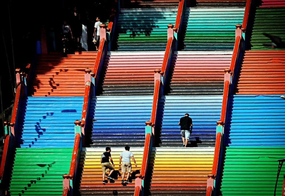 people sitting on brown wooden stairs
