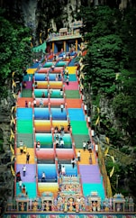 people walking on street near red and blue building during daytime