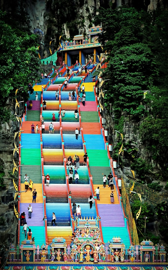 people walking on street near red and blue building during daytime in Batu Caves Malaysia