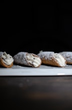 brown bread with white icing on white ceramic plate