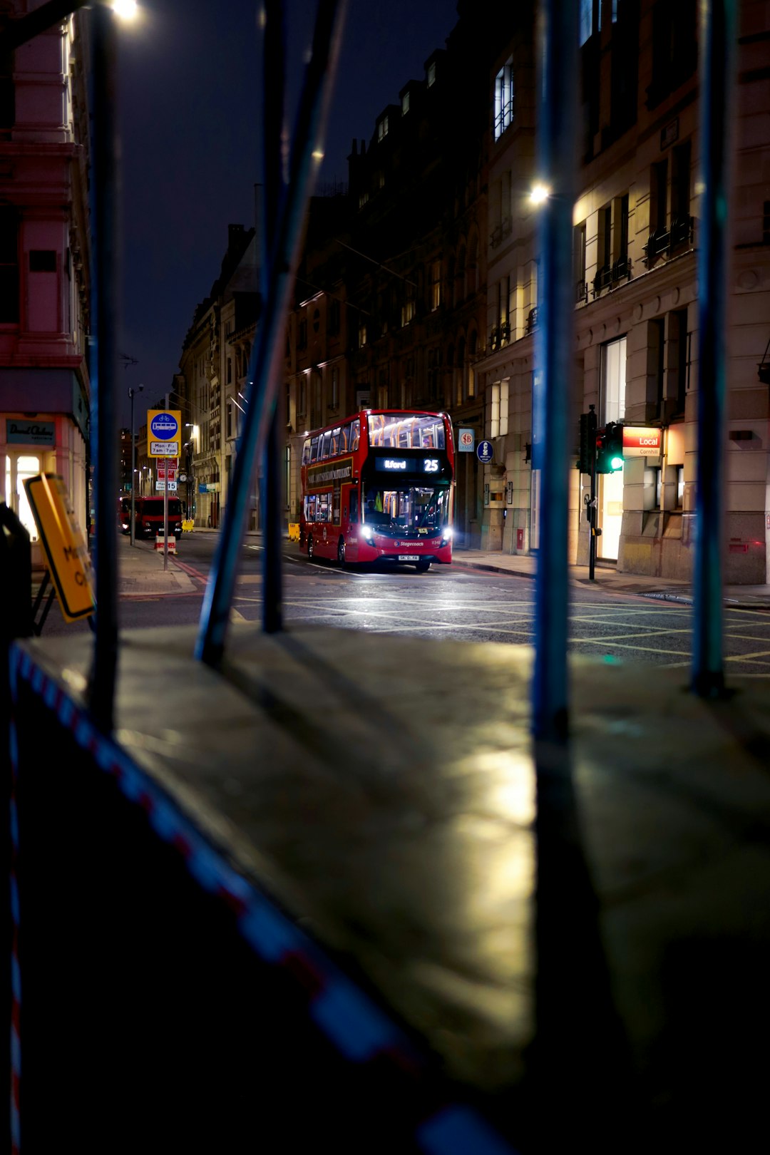 red double decker bus on road during night time