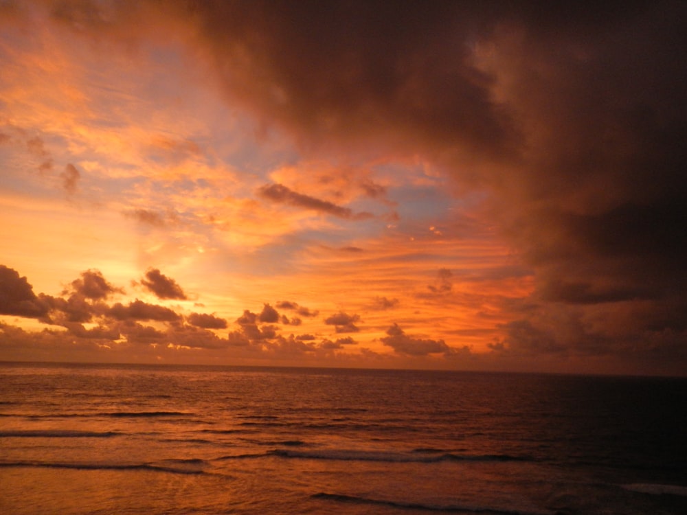 body of water during sunset