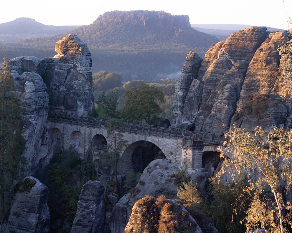 gray concrete bridge on top of mountain during daytime