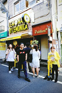 A small local shop owner handing out flyers with QR codes to smiling customers on a sunny street.