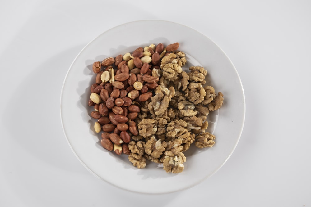 brown peanuts on white ceramic bowl