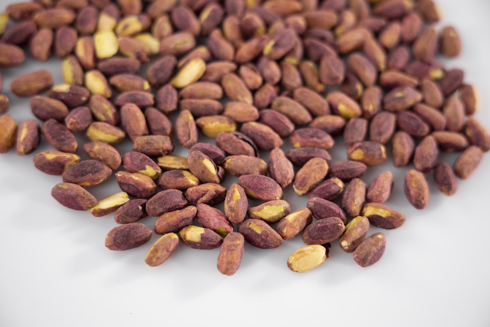 brown almond nuts on white ceramic plate