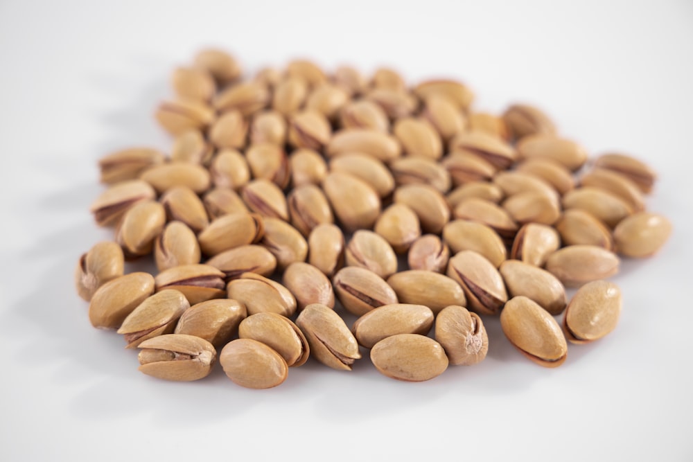 brown almond nuts on white surface