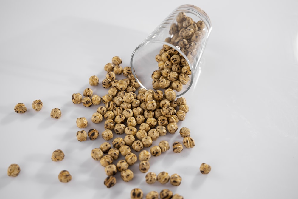 brown coffee beans in clear glass jar