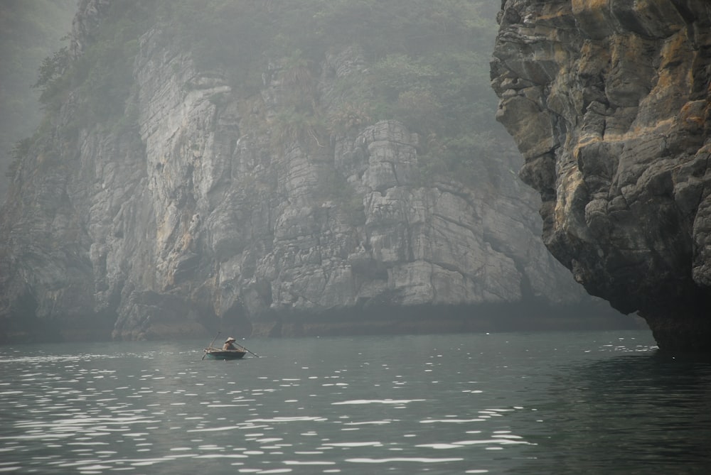 person riding on boat on body of water during daytime