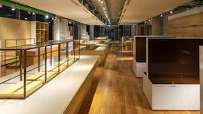 Furniture pieces and shelving units arranged thoughtfully in a bright studio space.