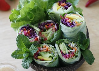 Coconut bowl full of fresh spring rolls