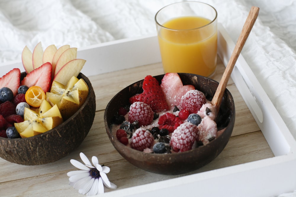 Fresas y arándanos en un cuenco de madera marrón