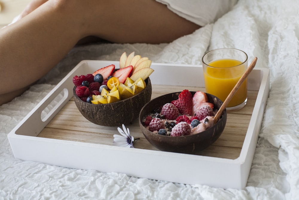 red and black berries on brown wooden tray