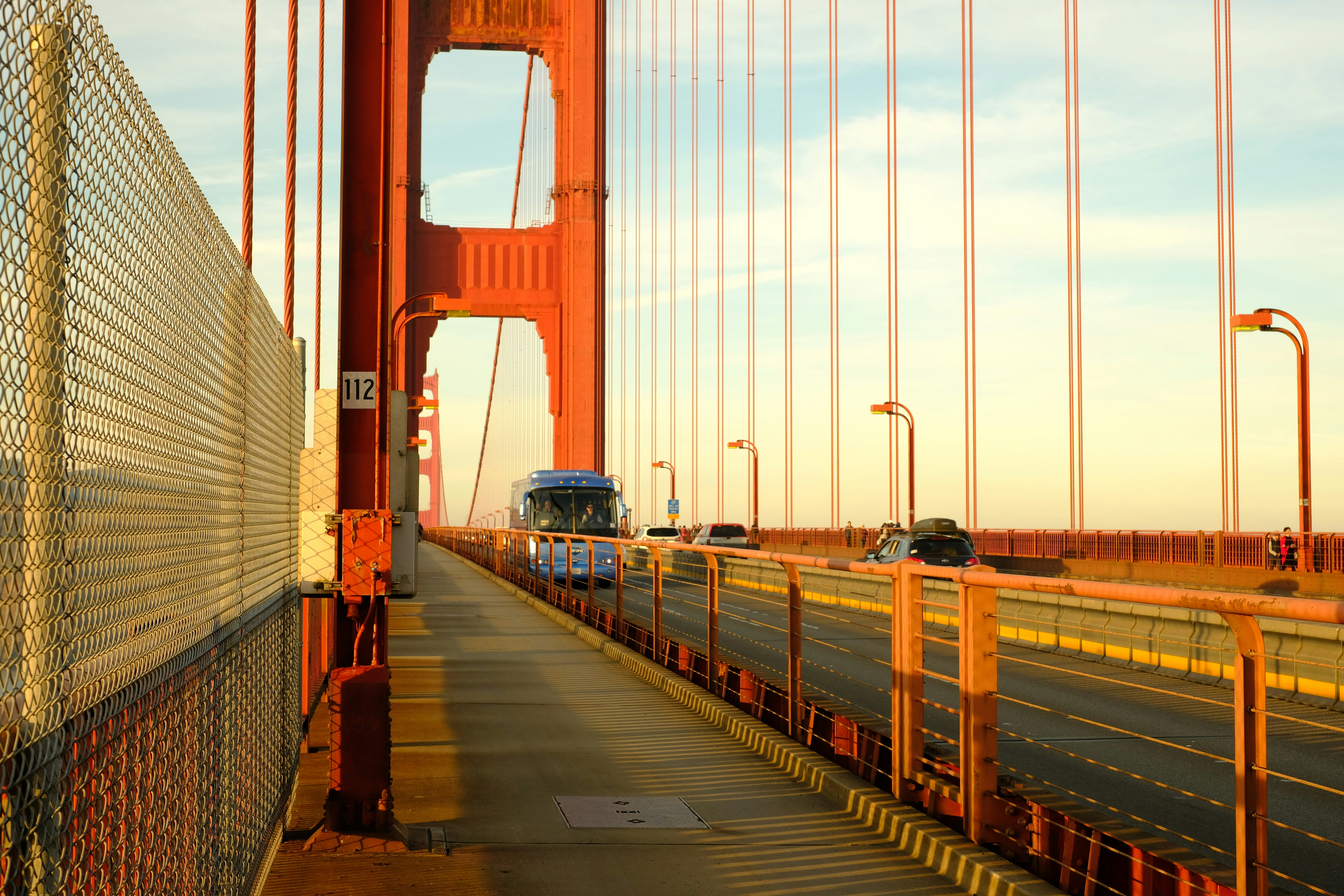 red bridge over body of water during daytime
