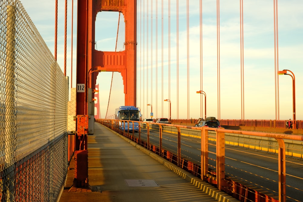 red bridge over body of water during daytime