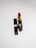 A tube of luxurious red lipstick stands upright, with an elegant black casing featuring a gold accent and a prominent logo on the cap. The background is a soft, light gradient that adds a sophisticated touch.
