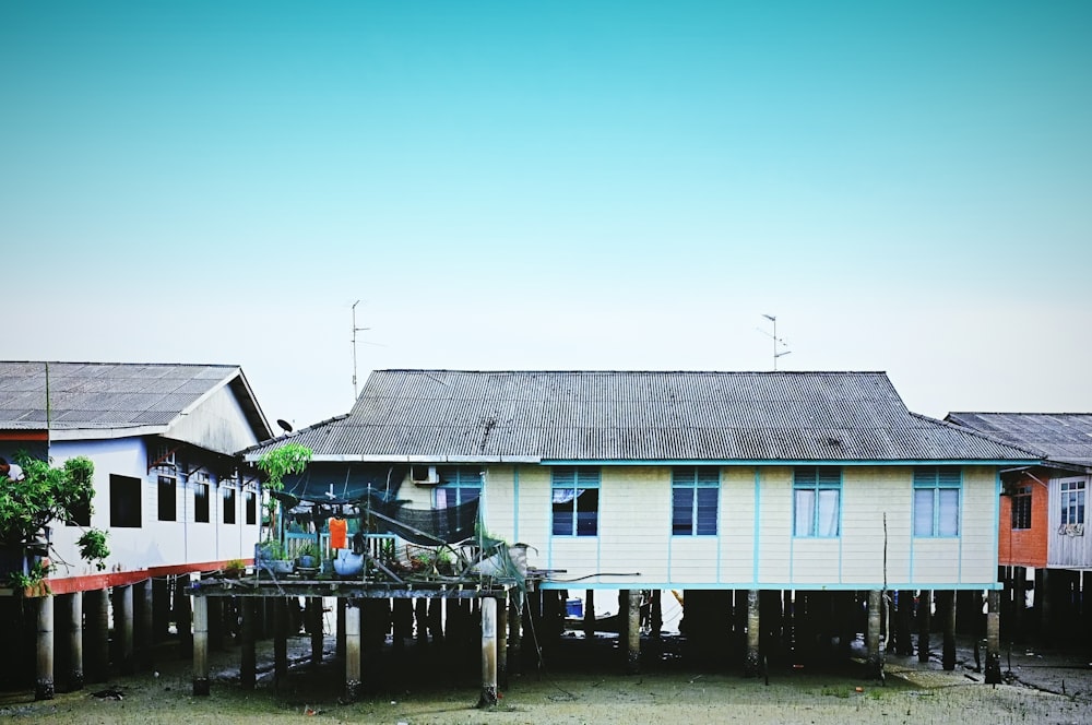 white and blue wooden house near body of water during daytime